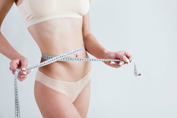 istock Underwear model with tape measure in studio. 1402672791