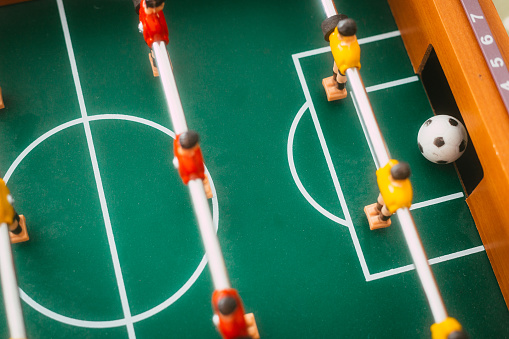 A table football player about to score a goal.