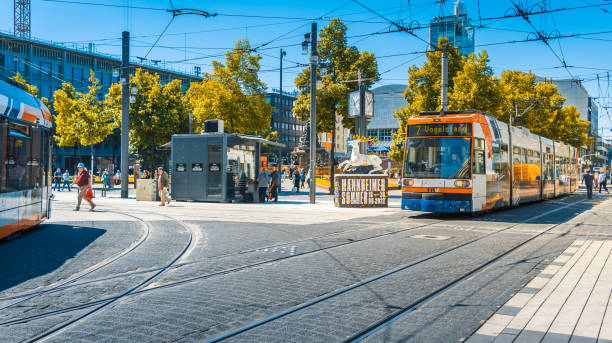 Colorful trams in Mannheim city, shopping center without  cars Mannheim, Germany - June 10, 2022:  Colorful trams in Mannheim city, shopping center without  cars. Paradeplatz is popular meeting place for shopping or lunch. mannheim photos stock pictures, royalty-free photos & images