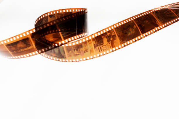Long filmstrip on white background Camera Film, Film Reel, White Background, Aging Process, Brown, Cut Out, Film Negative negative image technique photos stock pictures, royalty-free photos & images