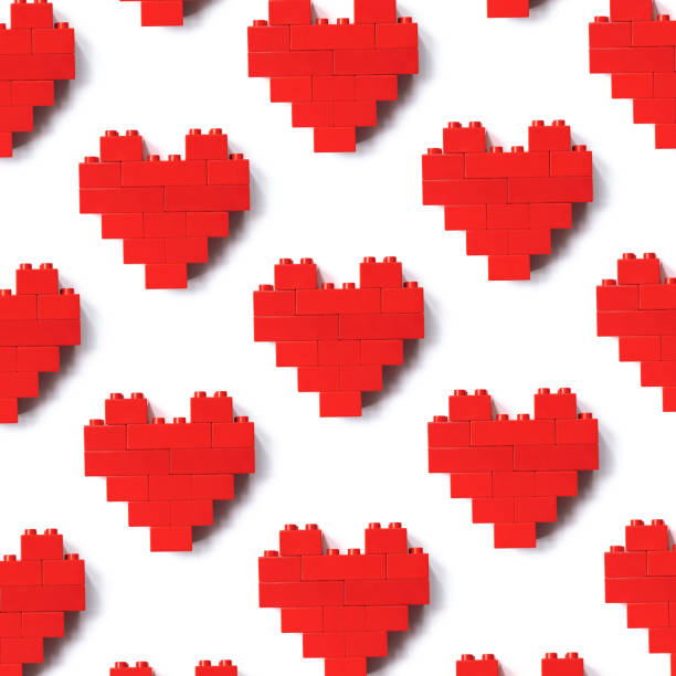 istock Red hearts from plastic building block blocks isolated on white background, minimal geometric pattern from plastic building block bricks, shape heart from child construction. Love game concept, Valentine Day card, top view pattern 1402679487