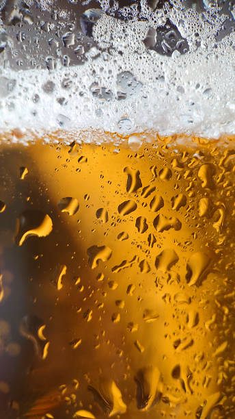 istock Macro composition golden beer with bubbles and foam in a glass 1402680893