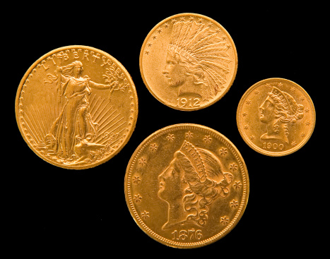 Four US gold coins from the 19th and 20th centuries.