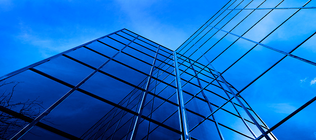 Business building with mirrored windows highrise financial with sky and clouds