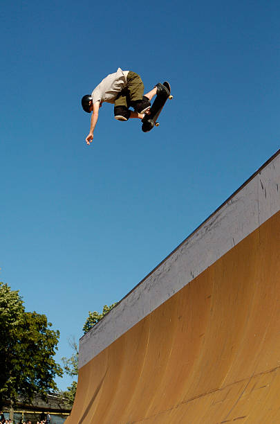 Skateboarder Backside Air Skateboarder performing a backside Air in the half pipe. x games stock pictures, royalty-free photos & images