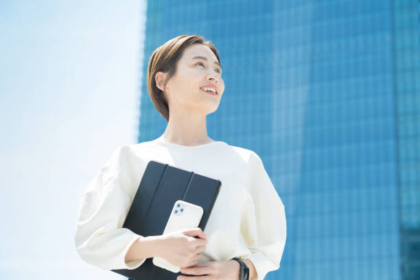 istock Woman looking up at the sky (business woman) 1402686086