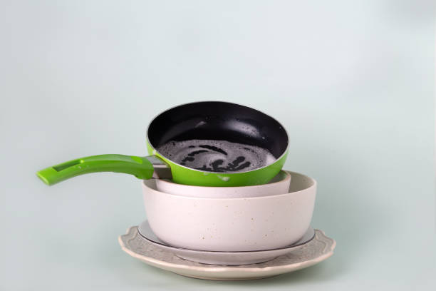 stack of dirty dishes on a blue background, selective focus