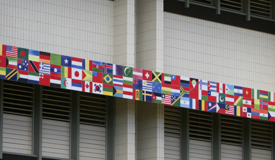 G7 Country flags on White Brick Wall. USA England Japan France Italy Germany Canada Flags 3D Render