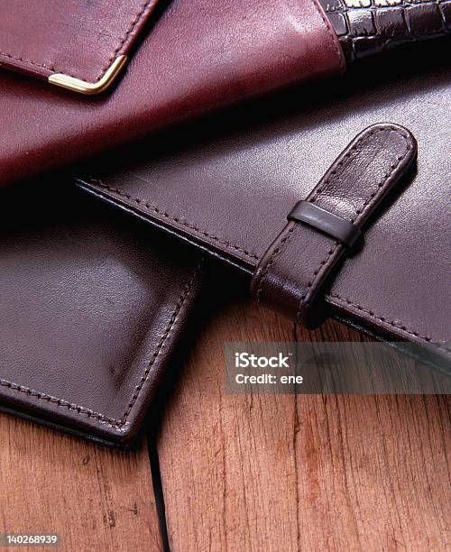 A Pile Of Leather Cases On A Wooden Table Stock Photo - Download Image Now - Accessibility, Black Color, Brown