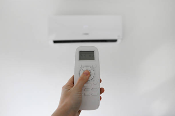 istock Turning on an air conditioner 1402689592