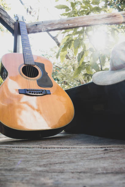istock guitar on wood plus a saxophone case and hat 1402689610