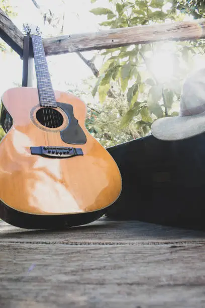 guitar on wood plus a saxophone case and hat in Mississippi State, Mississippi, United States