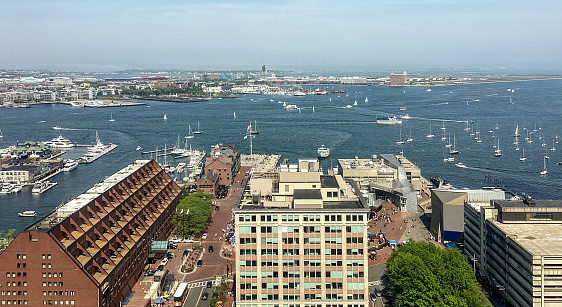 Boston, Massachusetts, USA - May 24, 2022: Panoramic High view of the city of Boston Cityscape Skyline Panorama Looking East Towards the Boston Harbor and the North End. Charlestown can be seen across the Charles River above the North End.