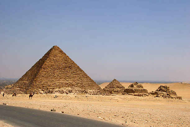 small pyramid with three step pyramids in Giza stock photo