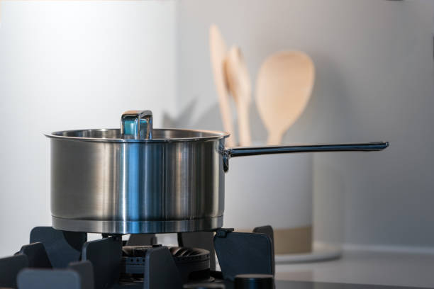 istock stainless steel pot on electronic modern flat stove in low light on counter kitchen room 1402691280