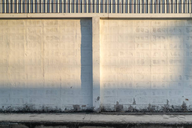 istock the empty clean and clear copy sapce Concrete brick block wall with the light and shadow shade on it. 1402691563