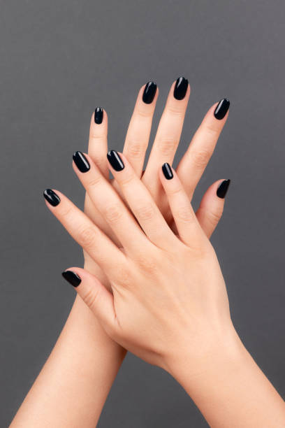 istock Female hands with black nails 1402693293