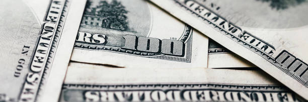 istock American paper dollar bills background banner 1402694020