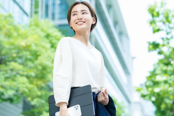 istock A smiling woman standing in the office district 1402694199