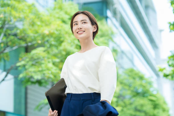 istock A smiling woman standing in the office district 1402694288