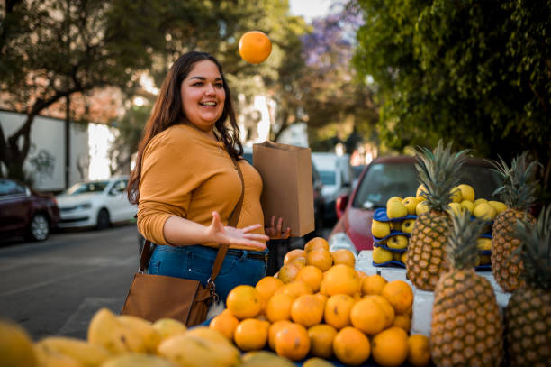 istock Woman juggling orange 1402696001