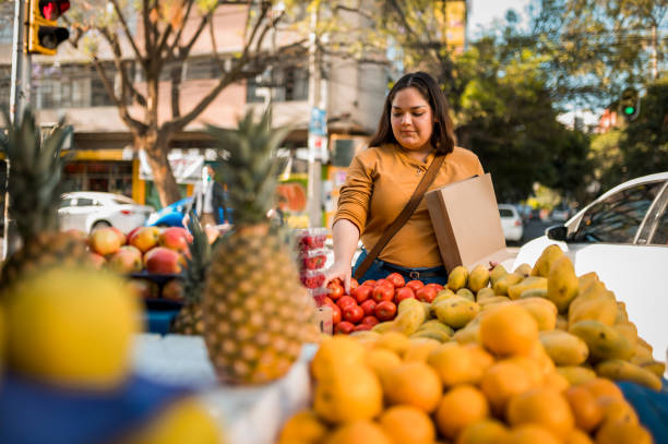 istock Woman choosing fruit at local market 1402696005