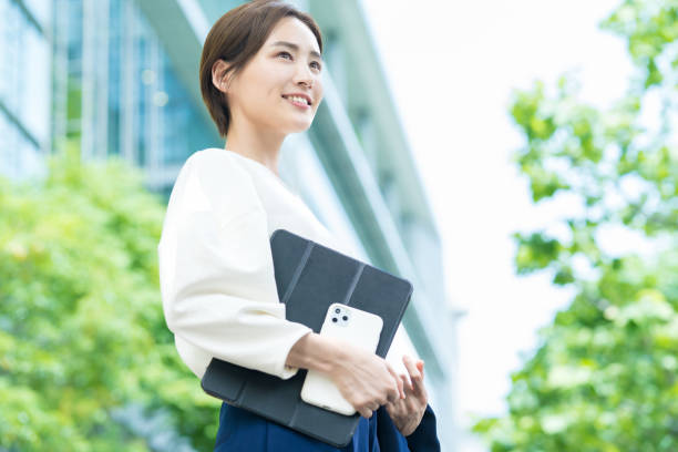 istock Woman looking up at the sky (business woman) 1402697467