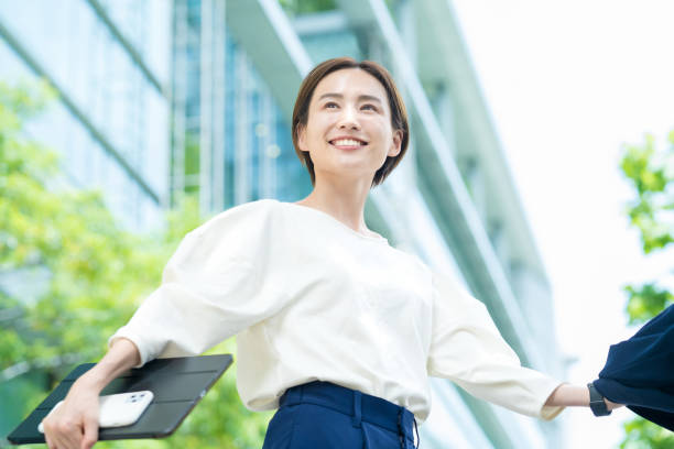 istock Woman looking up at the sky (business woman) 1402697550