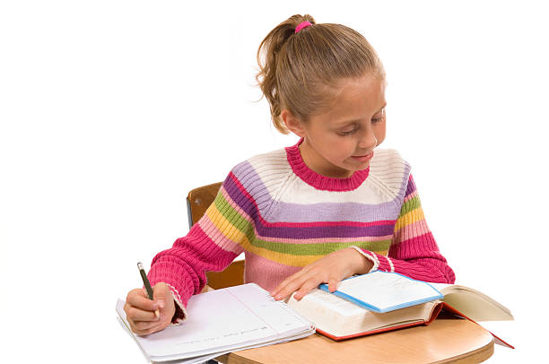 istock Young Girl at desk in school on white 140269844