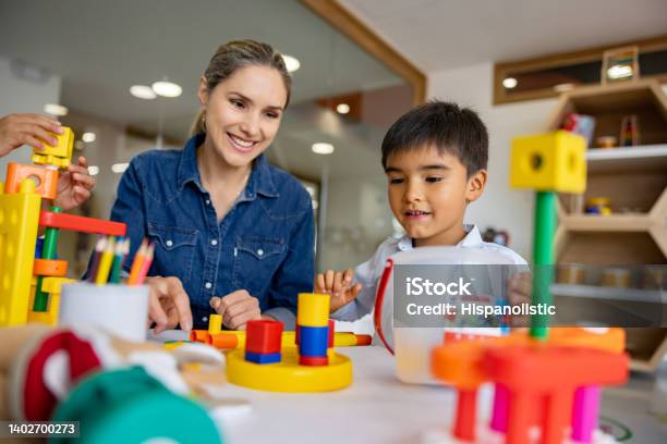 Schoolboy Playing With Building Blocks In The Classroom Stock Photo - Download Image Now