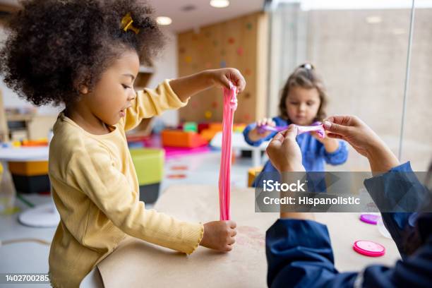 Girls Playing With Slime In Class At The School Stock Photo - Download Image Now - Child, Preschool, Slimy