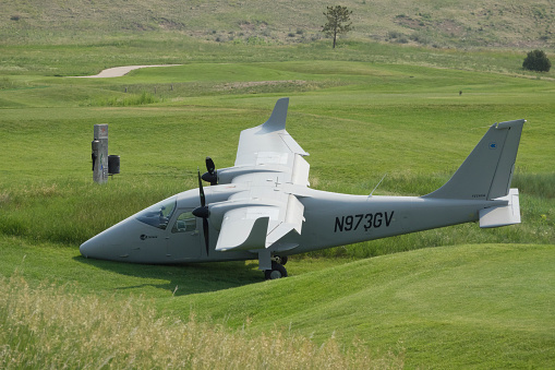 A front view of an old World War II airplane showing the engine and propeller