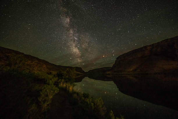 Milky Way over reservoir at Snake River at the Swan Falls dam The Snake River flows through a steep canyon at the Morley Nelson Snake River Birds of Prey National Conservation Area in Idaho nature reserve stock pictures, royalty-free photos & images