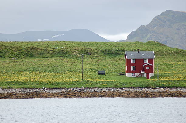 istock Red house on the meadow 140270216