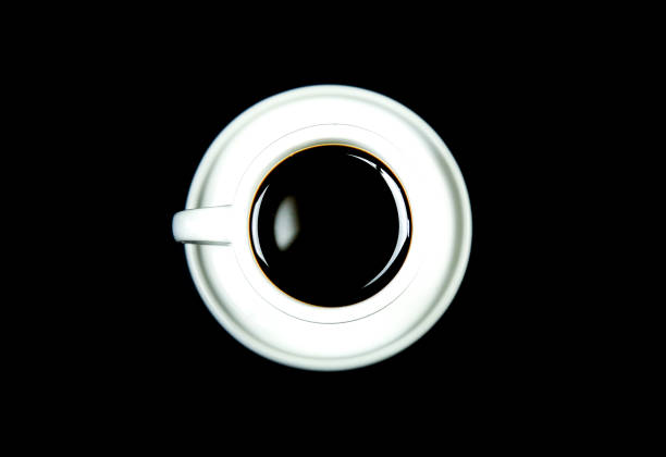 istock White cup of coffee on black background 1402702382
