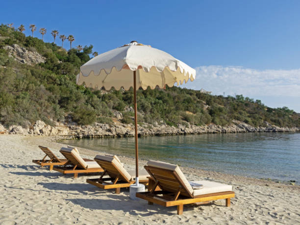 istock Beach chairs with umbrellas and beautiful sand beach 1402706646