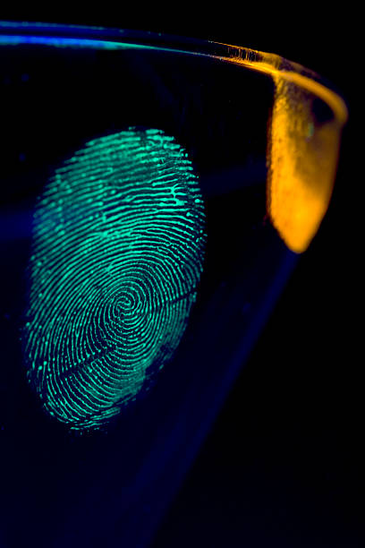 istock Glowing fingerprint and DNA on a glass representing a crime 140270877