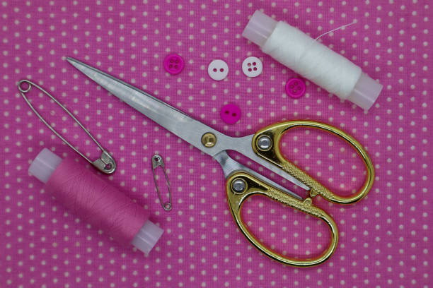 istock Set of sewing accessories on a pink background. Fabric, threads and scissors. Top view 1402708952
