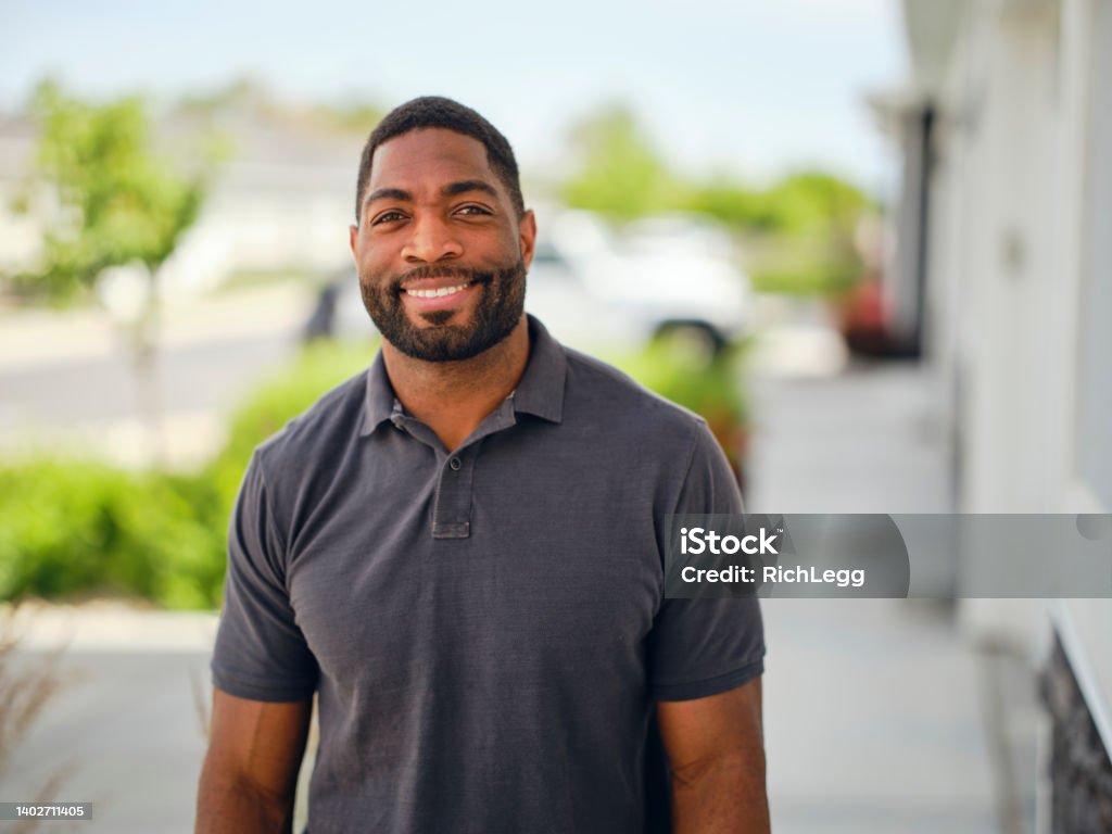 Portrait of a Man Outdoors A portrait of an African American man standing outdoors. 30-34 Years Stock Photo