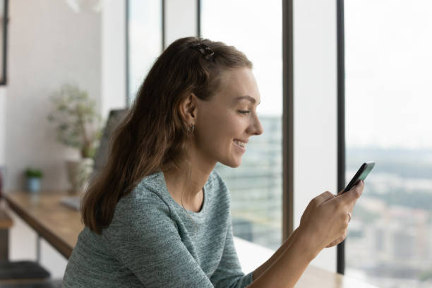 istock Smiling Caucasian woman use cellphone browsing internet 1402711484