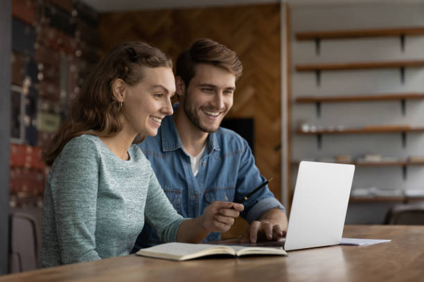 istock Happy diverse colleagues work on laptop at workplace 1402711500