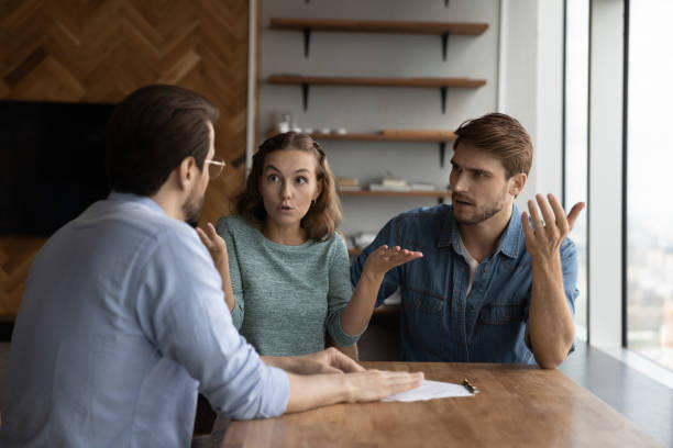 istock Unhappy couple clients distressed with contract terms 1402711515