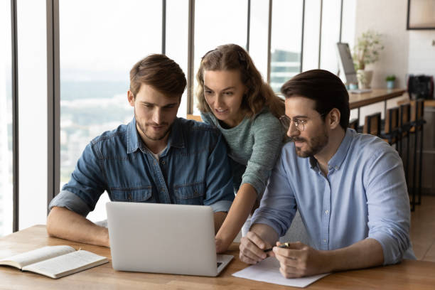 istock Diverse employee work on laptop in office together 1402711526