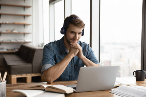 istock Young Caucasian man in headphones study online 1402711537