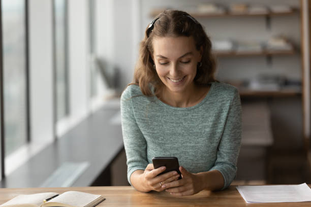 istock Smiling Caucasian woman use cellphone browsing internet 1402711539