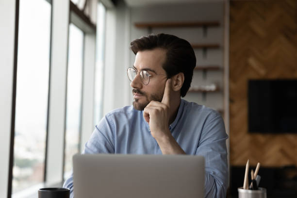 istock Pensive male employee feel bored working on computer 1402711542