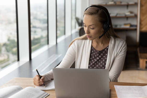 istock Pensive woman in headphones study online on computer 1402711594