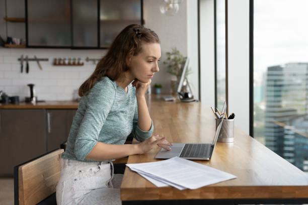 istock Pensive Caucasian woman work online on laptop 1402711982