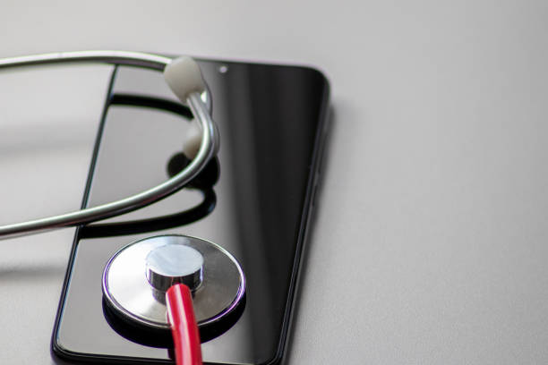 red stethoscope on black smartphone represents health records and digital patient records with mobile devices for digital doctors and digital diagnostic treatment with modern equipment and technology - doctor electronic organizer healthcare and medicine patient imagens e fotografias de stock