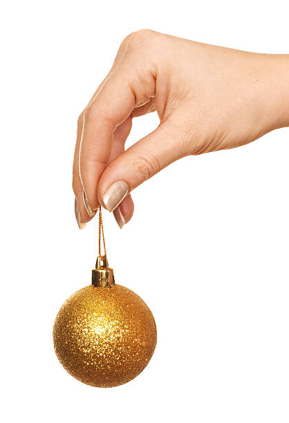 istock hand holding gold Christmas ball 140271357
